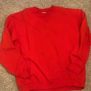 Crewneck sweatshirt in vibrant coral/red.